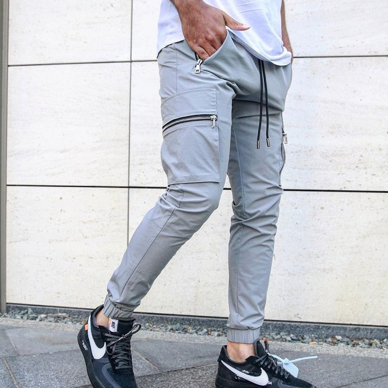 Calça Zip Pocket Men's Cargo Pants calça cargo versátil e estilosa que possa levá-lo da academia para a rua? Não procure mais, nossas calças cargo masculinas com bolso com zíper.