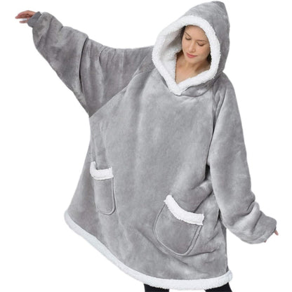 Casaco Hoodie Blanket o cobertor com capuz. Esta manta estilosa e confortável é confeccionada com tecido de lã coral que lhe confere uma textura macia e luxuosa que certamente o manterá aquecido nos dias frios.